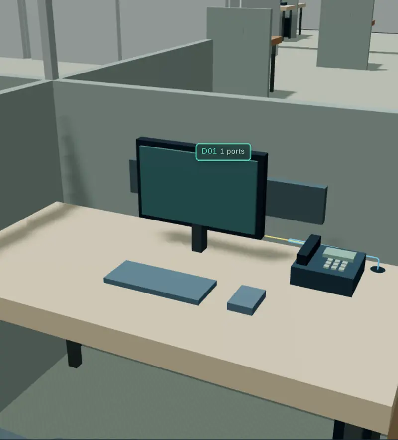 3D close-up of a cubicle desk with an IP desk phone and its data outlet, in Network Studio